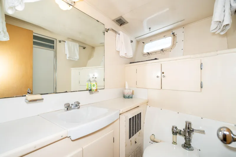 Slide: The Image of Vintage 1965 Burger Motoryacht bathroom with sink, mirror, and storage cabinets. - 45