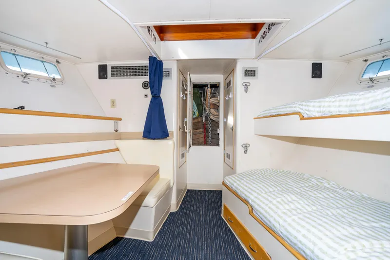 Slide: The Image of Interior of a 1965 Burger Motoryacht with bunk beds and dining area. - 46