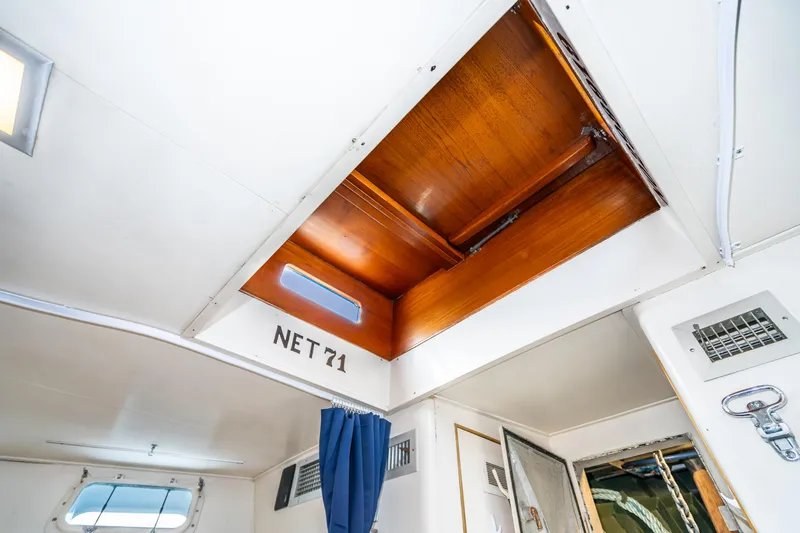Slide: The Image of Interior view of 1965 Burger Motoryacht with wooden hatch and blue curtain. - 49