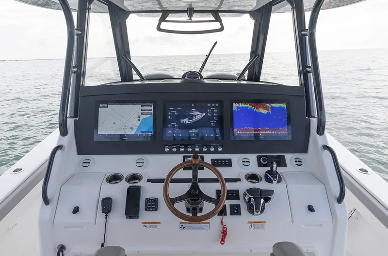 Slide: The Image of 2025 Regulator 35 boat dashboard with advanced navigation screens and controls. - 3