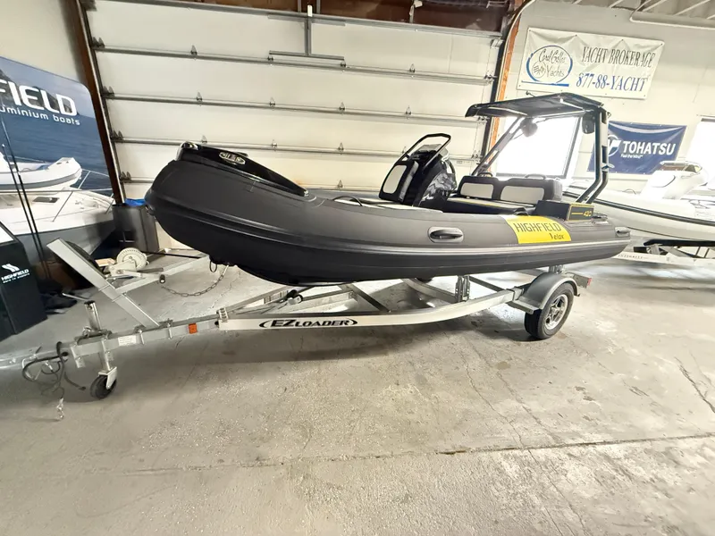 The Image of 2025 Highfield Velox 420 boat on EZ Loader trailer in showroom. - 0