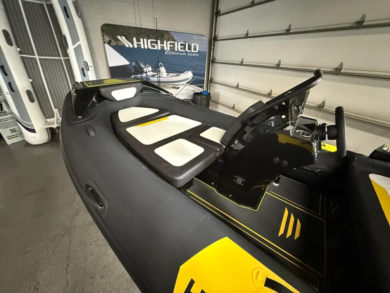Slide: The Image of 2025 Highfield Velox 420 boat interior with sleek black and yellow design. - 2
