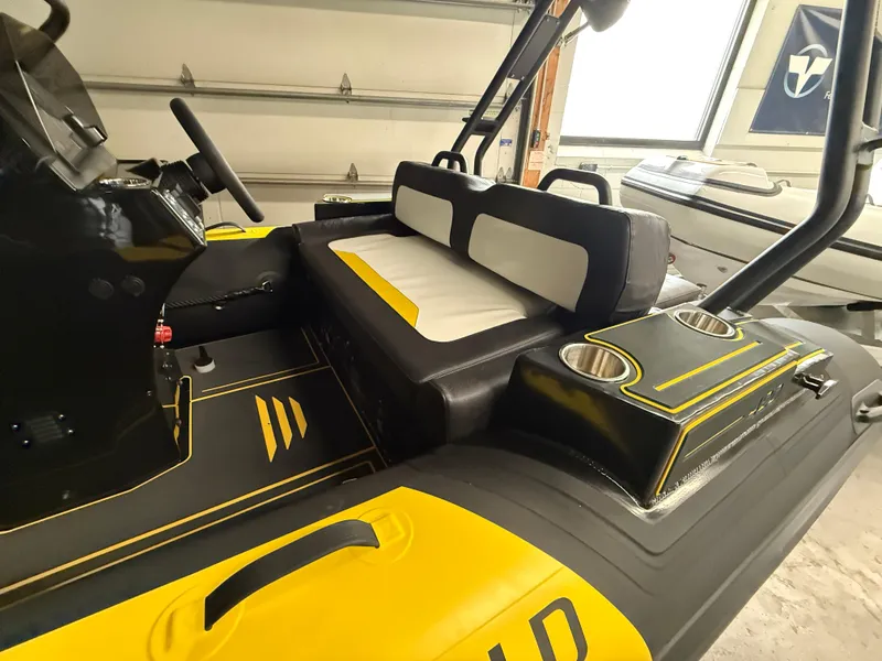 Slide: The Image of 2025 Highfield Velox 420 boat interior with black and yellow seating and cup holders. - 4