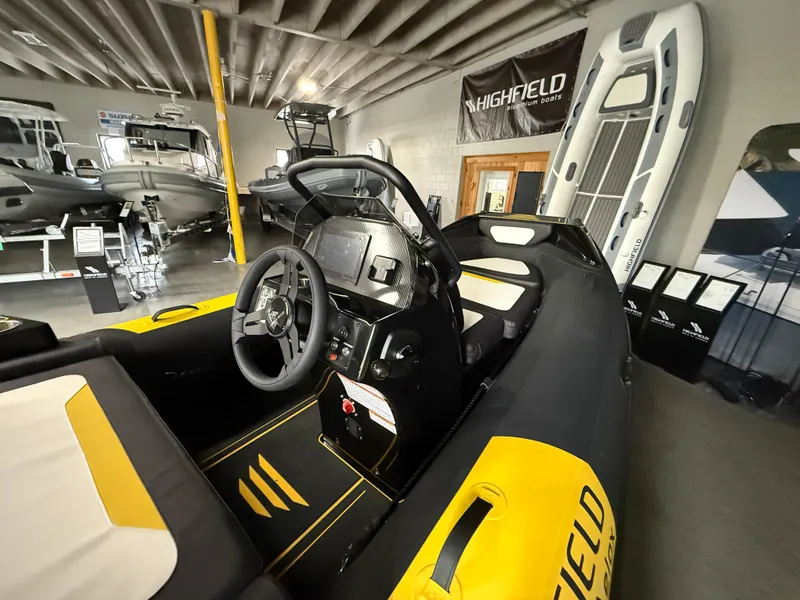 Slide: The Image of 2025 Highfield Velox 420 boat interior in showroom, featuring modern design and controls. - 7