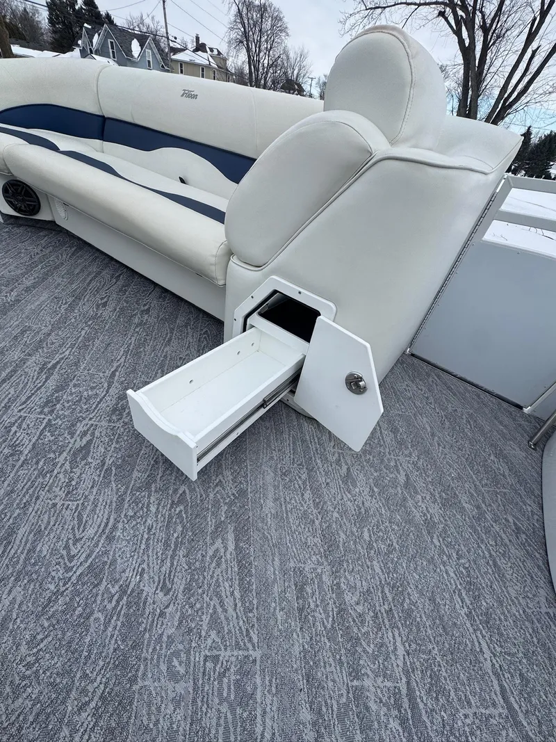 Slide: The Image of 2022 JC Neptoon 25TT boat with white seating and storage drawer open. - 6
