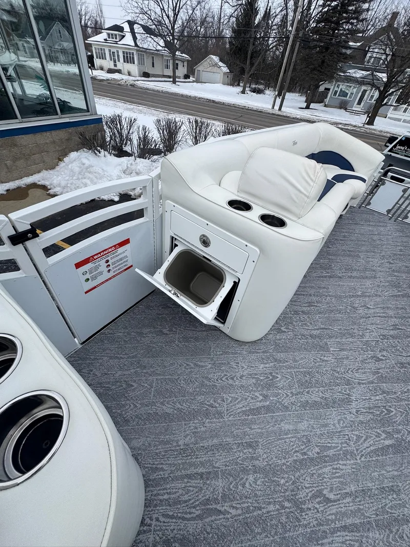 Slide: The Image of 2022 JC Neptoon 25TT boat interior with white seating and storage compartment. - 10