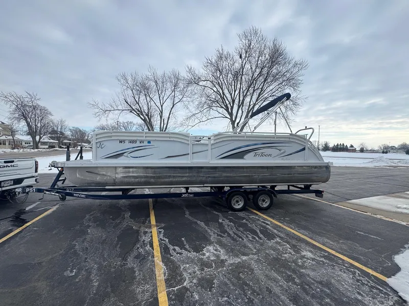 Slide: The Image of 2022 JC Neptoon 25TT pontoon boat on trailer in snowy parking lot. - 2
