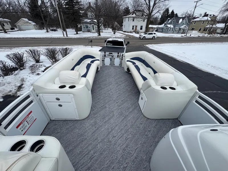 Slide: The Image of 2022 JC Neptoon 25TT pontoon boat with spacious seating and modern design in snowy setting. - 4