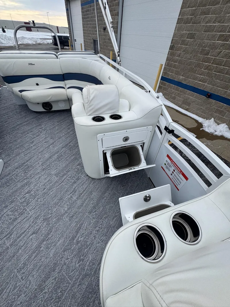 Slide: The Image of 2022 JC Neptoon 25TT boat interior with white seating and storage compartments. - 5