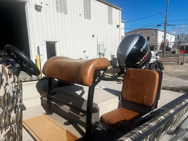 Slide: The Image of 2023 Avid 20 Rogue boat with Yamaha outboard motor, parked outdoors. - 6