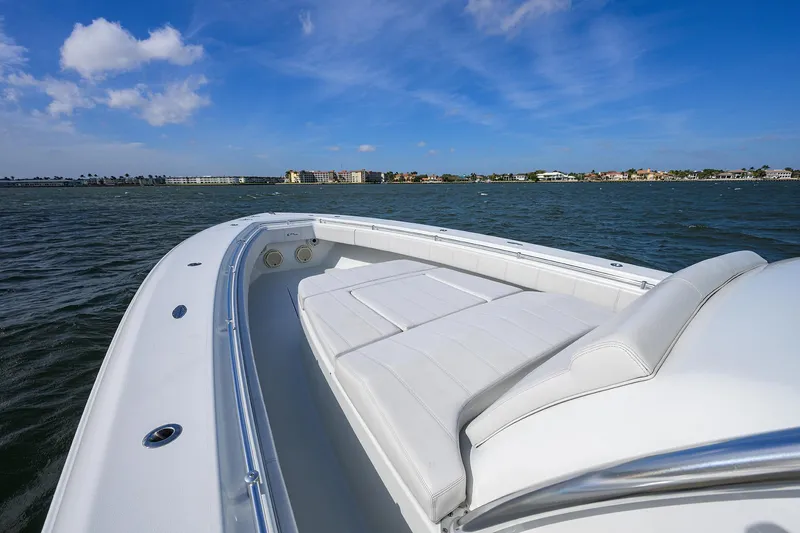 Slide: The Image of 2022 Contender 44FA boat with white seating, cruising on a sunny day. - 17