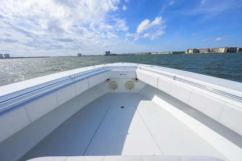 Slide: The Image of 2022 Contender 44FA boat on open water under a clear blue sky. - 19