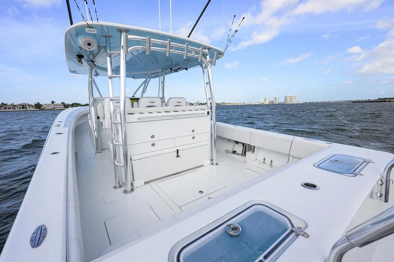 Slide: The Image of 2022 Contender 44FA boat on water, featuring spacious deck and modern design. - 27