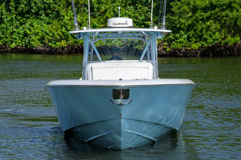 Slide: The Image of 2022 Contender 44FA boat on water, front view, lush greenery background. - 3