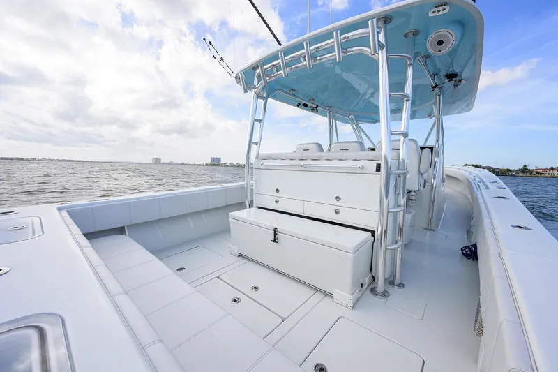 Slide: The Image of 2022 Contender 44FA boat with spacious deck and seating, cruising on open water. - 31