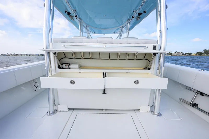 Slide: The Image of 2022 Contender 44FA boat interior with storage compartments open, showcasing sleek design. - 32