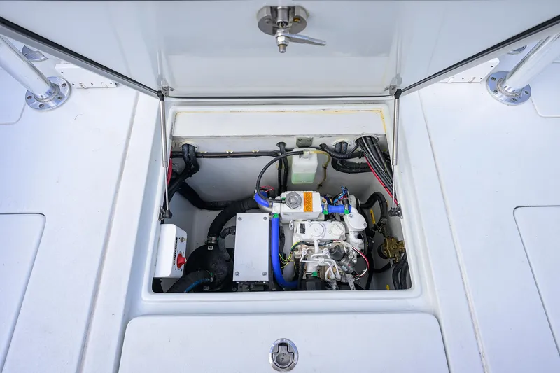 Slide: The Image of Engine compartment of 2022 Contender 44FA boat, showcasing internal components and wiring. - 34