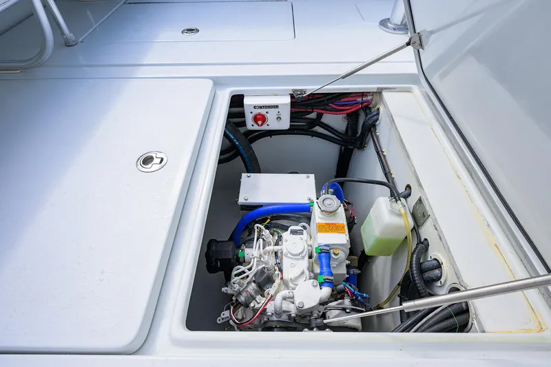 Slide: The Image of Engine compartment of 2022 Contender 44FA boat, showcasing mechanical components and wiring. - 35