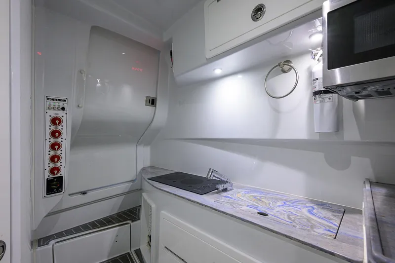 Slide: The Image of Interior of 2022 Contender 44FA boat, featuring modern kitchen amenities and sleek design. - 38