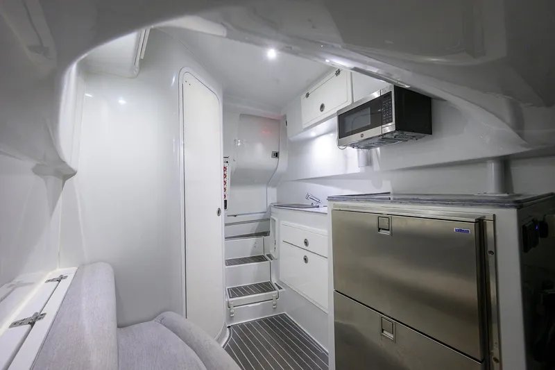 Slide: The Image of 2022 Contender 44FA interior with modern kitchen, stainless appliances, and sleek cabinetry. - 41