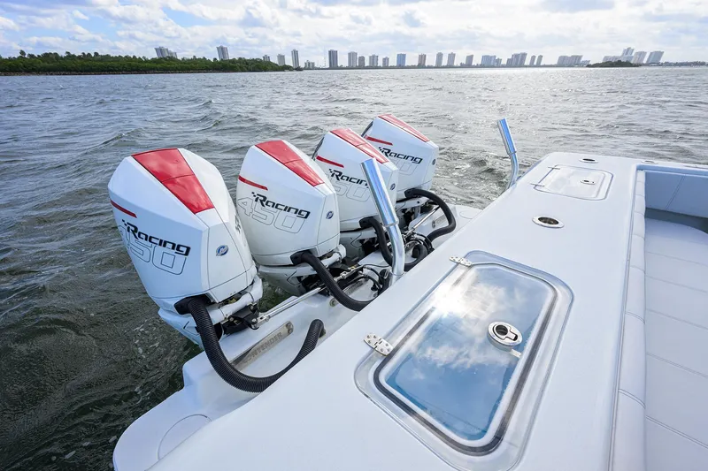 Slide: The Image of 2022 Contender 44FA boat with triple outboard engines on open water. - 47