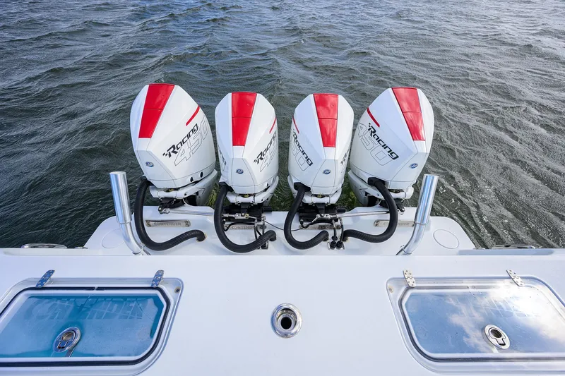 Slide: The Image of Four powerful outboard motors on a 2022 Contender 44FA boat, ready for high-speed performance. - 48