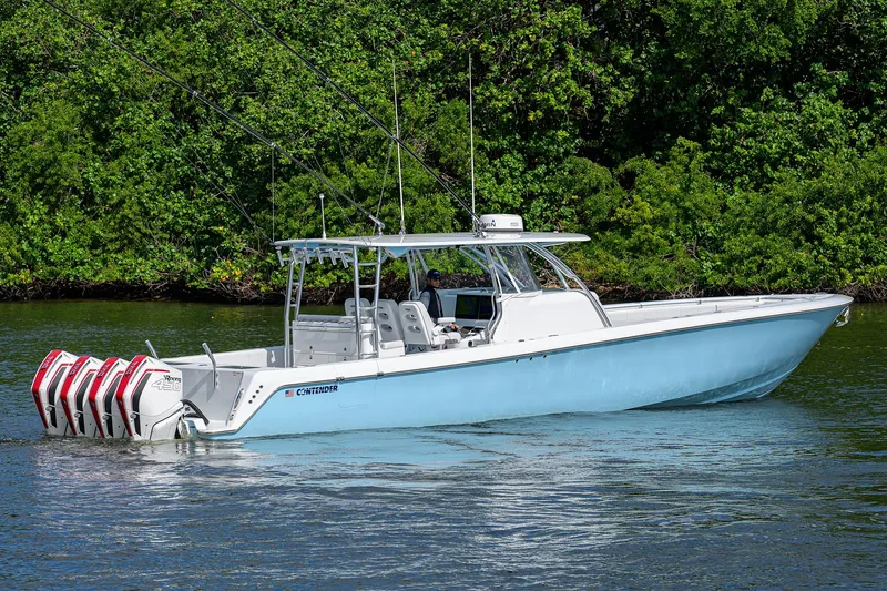Slide: The Image of 2022 Contender 44FA boat with multiple engines on a calm waterway. - 8