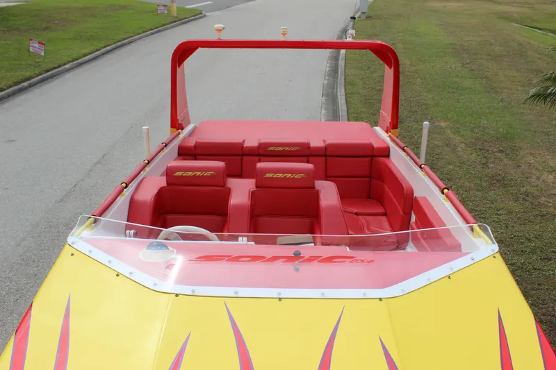 Slide: The Image of 2001 Sonic 42 SS speedboat with red and yellow design, featuring spacious seating. - 24