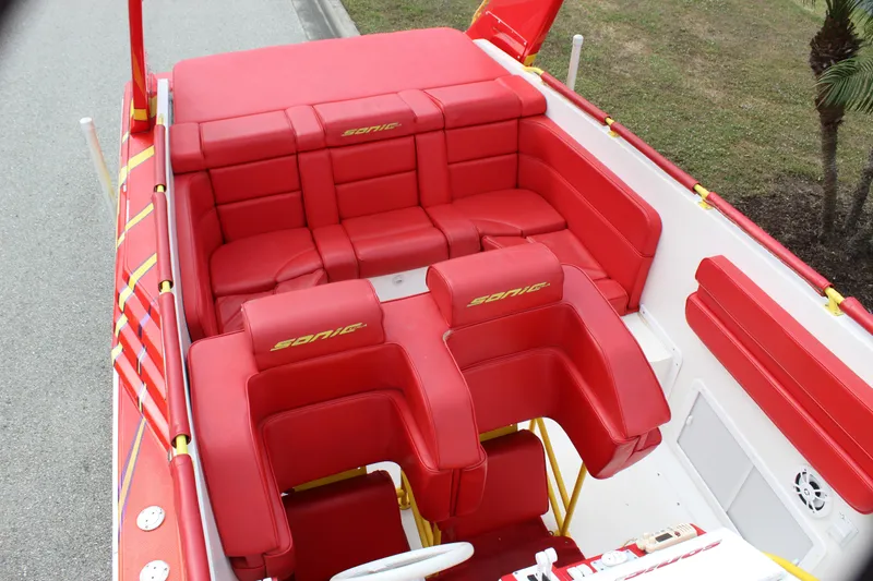 Slide: The Image of 2001 Sonic 42 SS boat interior with vibrant red seating and sleek design. - 27