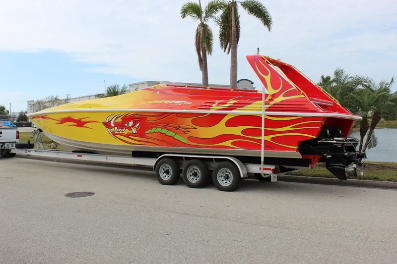 Slide: The Image of 2001 Sonic 42 SS speedboat with vibrant flame and dragon design on a trailer. - 3