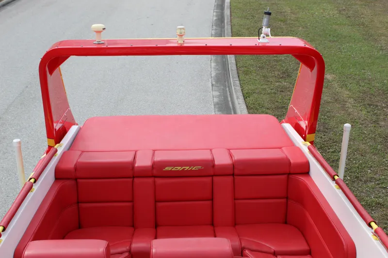 Slide: The Image of Red interior of a 2001 Sonic 42 SS boat with cushioned seating. - 30