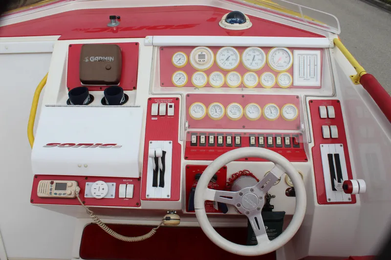 Slide: The Image of Control panel of a 2001 Sonic 42 SS boat with steering wheel and gauges. - 36