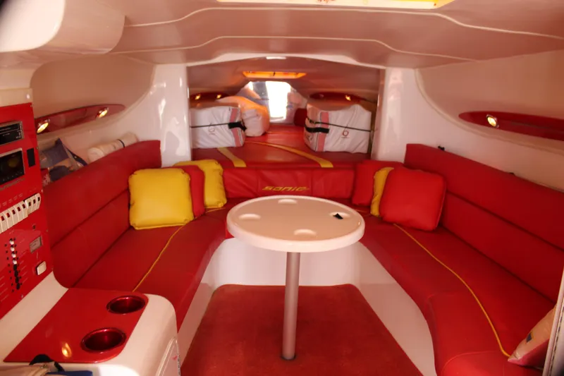 Slide: The Image of Interior of 2001 Sonic 42 SS boat with red seating and round table. - 39