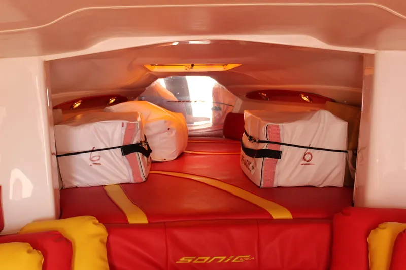Slide: The Image of Interior of 2001 Sonic 42 SS boat with red and yellow seating. - 42