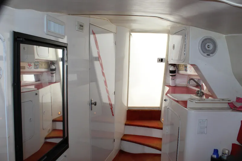 Slide: The Image of Interior of 2001 Sonic 42 SS boat with compact kitchen and stairs. - 46