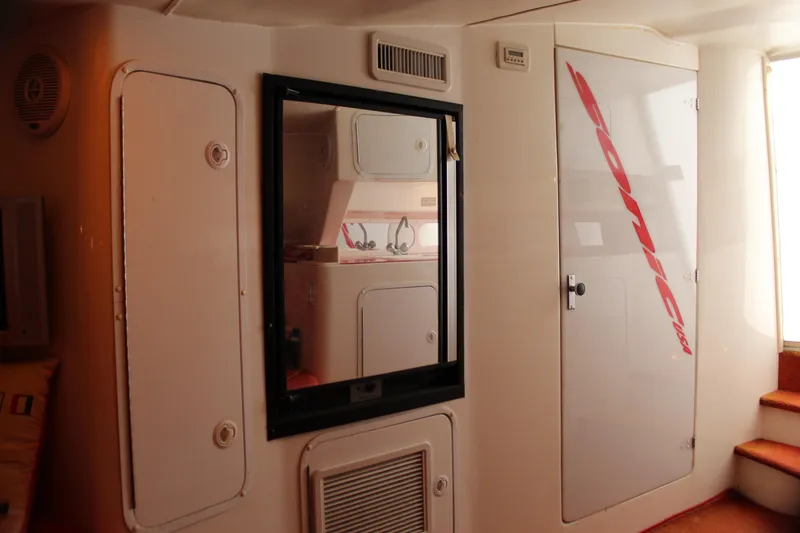 Slide: The Image of Interior of 2001 Sonic 42 SS boat with storage compartments and mirror. - 47