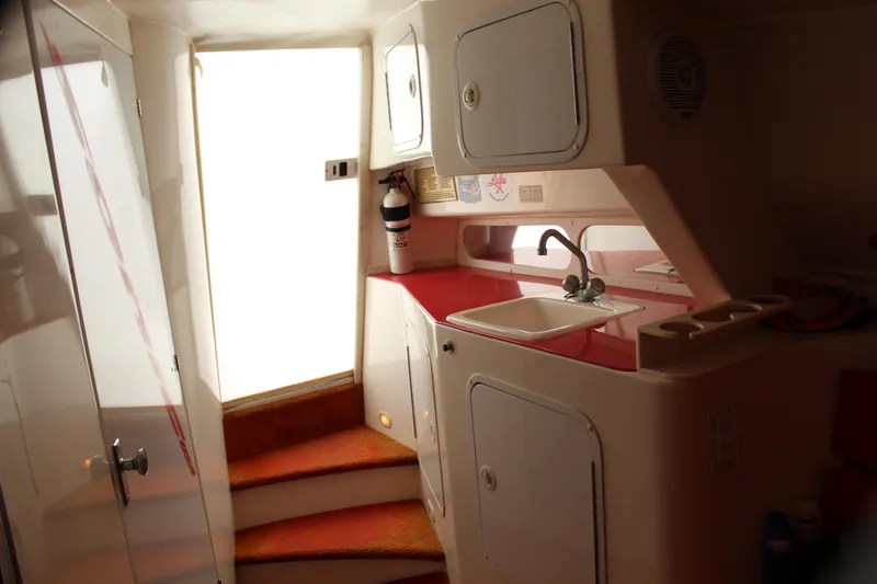 Slide: The Image of Interior of 2001 Sonic 42 SS boat with kitchenette and stairs. - 48