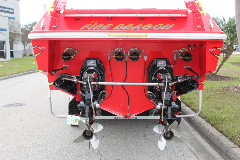 Slide: The Image of Rear view of a red 2001 Sonic 42 SS boat named "Fire Dragon" with dual propellers. - 7