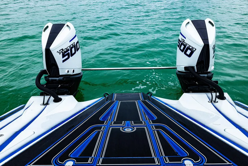 Slide: The Image of 2023 MTI 440X boat with twin 300R engines on a calm green sea. - 16
