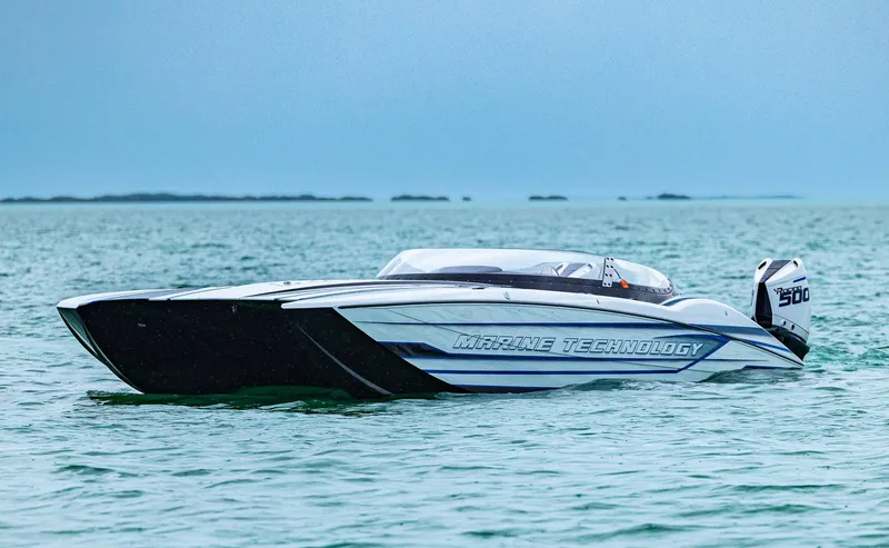 Slide: The Image of 2023 MTI 440X powerboat on calm water, showcasing sleek design and advanced technology. - 22