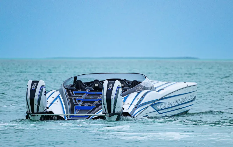 Slide: The Image of 2023 MTI 440X powerboat with dual engines on open water. - 3