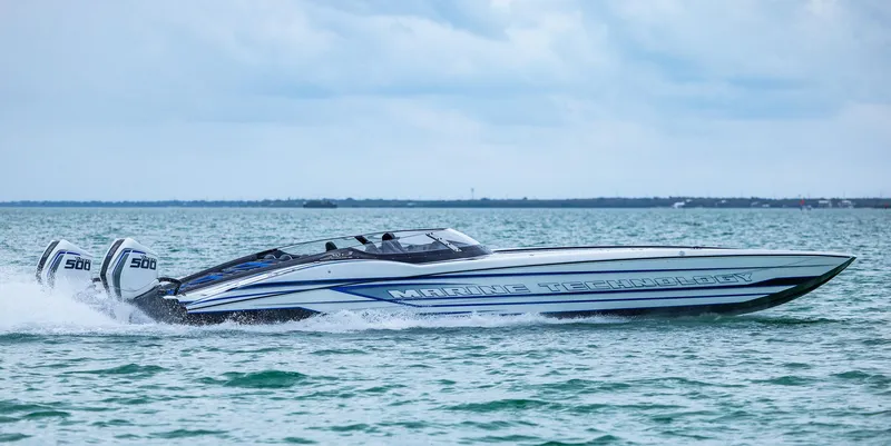 Slide: The Image of 2023 MTI 440X speedboat cruising on open water under a cloudy sky. - 8