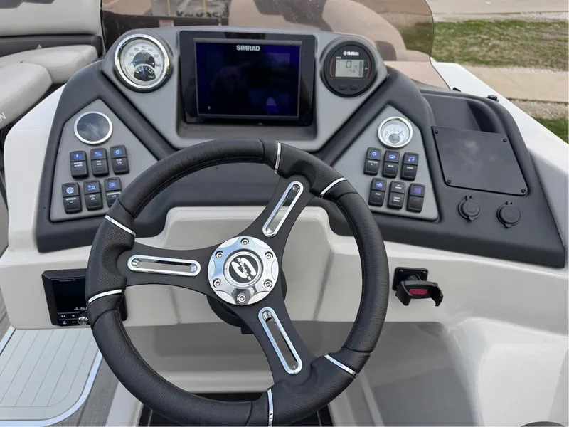 Slide: The Image of Steering console of 2023 Sylvan L5 DLZ Bar boat with modern controls and display. - 3