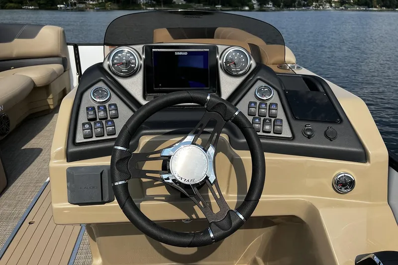 Slide: The Image of ```json
{
  "alt_text": "2023 Sylvan L5 DLZ Bar boat dashboard with steering wheel and controls."
}
``` - 32