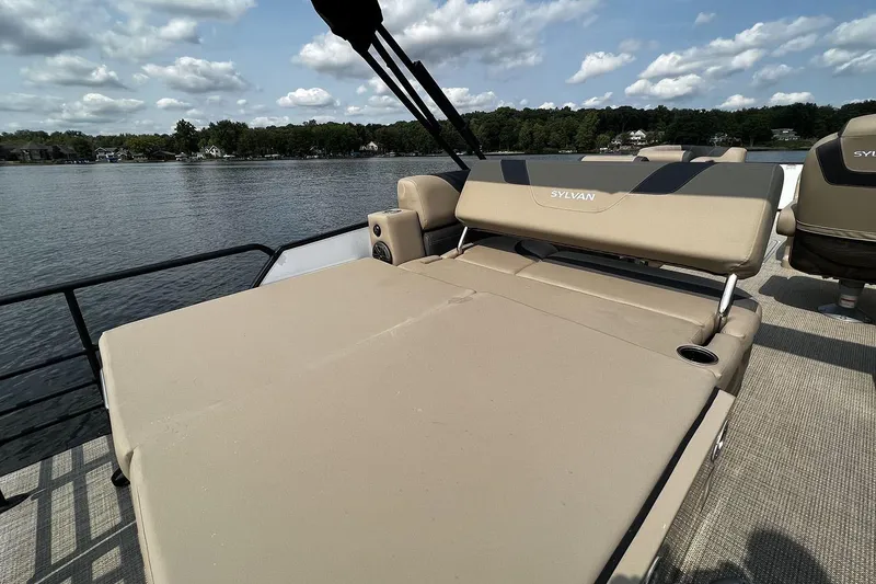 Slide: The Image of 2023 Sylvan L5 DLZ Bar pontoon boat with spacious seating on a serene lake. - 33