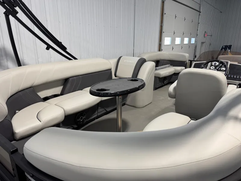 Slide: The Image of 2024 Sylvan MIRAGE 820 LZ interior with plush seating and table in a spacious layout. - 11