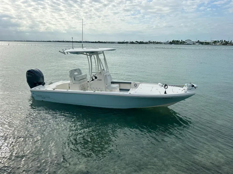 Slide: The Image of 2021 Pathfinder 2500 Hybrid boat on calm water under a cloudy sky. - 1