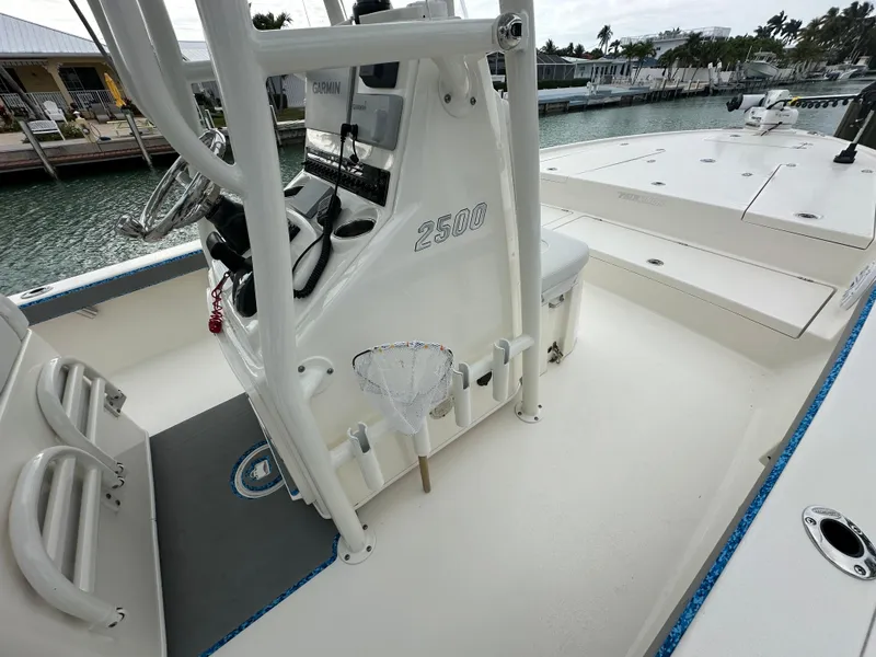 Slide: The Image of 2021 Pathfinder 2500 Hybrid boat interior with steering console and fishing net. - 11