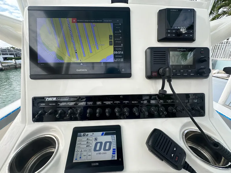Slide: The Image of Control panel of a 2021 Pathfinder 2500 Hybrid boat with navigation and communication devices. - 13