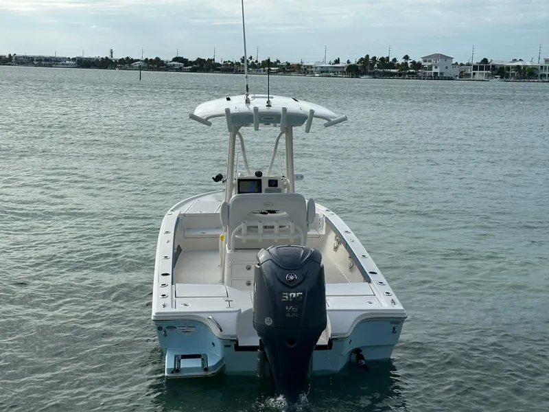 Slide: The Image of 2021 Pathfinder 2500 Hybrid boat on water, rear view with outboard motor. - 5